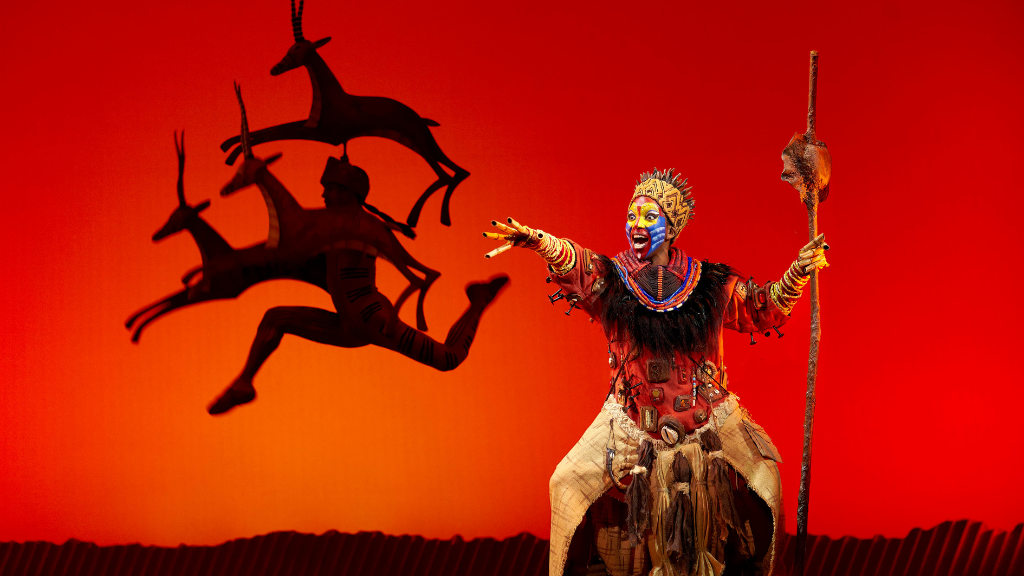 lion king, musical comedy, traditional costume, with dancing jumping antelopes, disney inspired, paris theatre, paris
